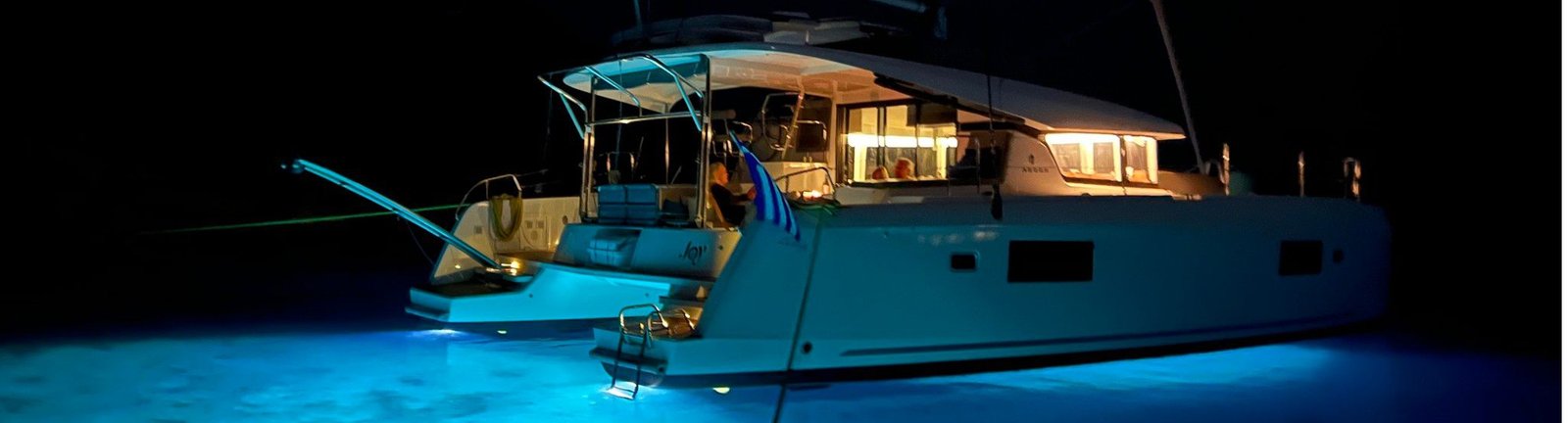 Catamaran anchored in clear water near the Greek Islands